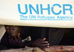 A Sudanese refugee peers during Refugee Day celebrations in Ikafe camp for Sudanese refugees in nort.