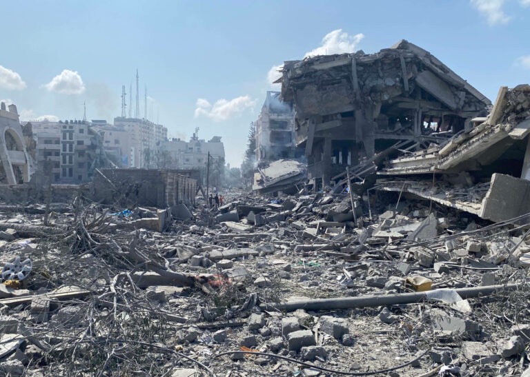 Palestinians inspect the damage following an Israeli airstrike on the El-Remal area in Gaza City